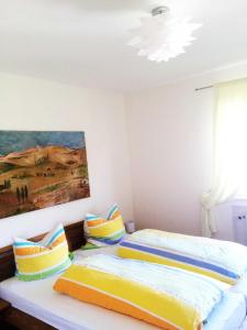 a bedroom with two beds and a painting on the wall at Ferienhof Christmann in Mossautal