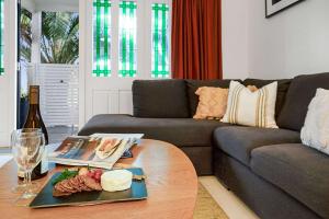 a living room with a couch and a coffee table at Apartment 22 - stylish retreat in central location in Fitzroy
