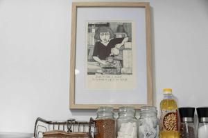 a picture of a woman in a kitchen with jars at Apartment 22 - stylish retreat in central location in Fitzroy