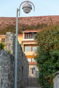 a street light next to a stone wall with a building at Apartments Kristić in Dubrovnik
