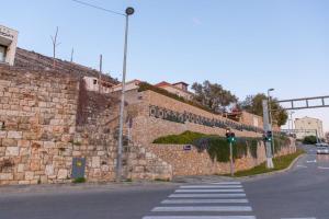 a stone wall next to a street with a traffic light at Apartments Kristić in Dubrovnik +32 photos