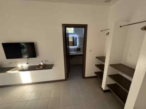 a bathroom with a sink and a television on a wall at Onda Resort Pacifico in San Isidro