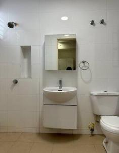 a white bathroom with a sink and a toilet at JM House Kuala Lumpur in Puchong