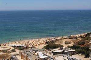 a beach with a lot of umbrellas and people at T3 1ºDto Lote 9 - Casas & Papeis in Bicas