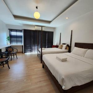 Ένα ή περισσότερα κρεβάτια σε δωμάτιο στο BOPIT Home Nimman