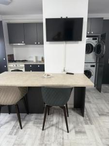 a kitchen with a large table and two chairs at La Lumina in Lumina