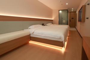 Ένα ή περισσότερα κρεβάτια σε δωμάτιο στο An Yi Hotel