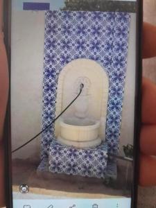 a glass box with a picture of a statue at Villa des deux frères in Midoun