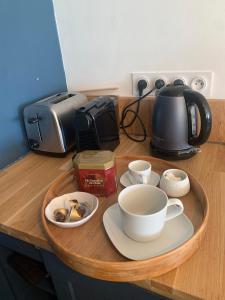 a tray with cups and saucers on top of a counter at T2 Magnifique vue mer panoramique in Six-Fours-les-Plages