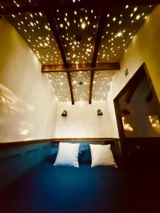 a room with a bed with lights on the ceiling at Worcester Escape in Hallow