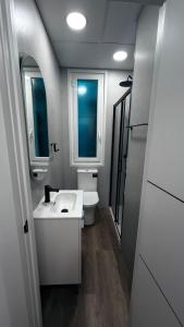 a bathroom with a white sink and a toilet at bcool in Bilbao