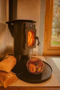 a stove with a loaf of bread and a basket of bread at Worcester Escape in Hallow +18 photos