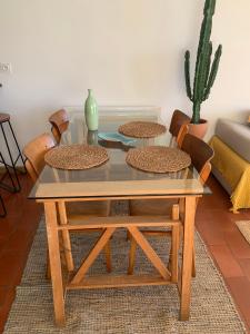a coffee table with four chairs and a glass top at T2 Magnifique vue mer panoramique in Six-Fours-les-Plages