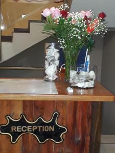 een tafel met een vaas met bloemen erop bij The Albatros Guesthouse in Margate +68 foto's