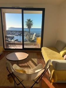 a living room with a view of the ocean at T2 Magnifique vue mer panoramique in Six-Fours-les-Plages +15 photos