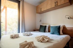 a bedroom with a bed with two pillows on it at Rives d'Arc in Vallon-Pont-dʼArc +135 photos