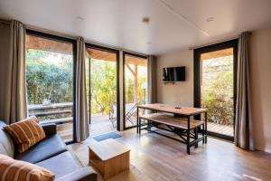 a living room with a couch and a table at Rives d'Arc in Vallon-Pont-dʼArc