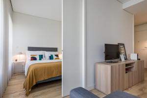 En eller flere senge i et værelse på Antas Park with pool and gym - to work & leisure + 15 billeder