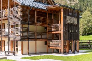a large wooden building with a sign on it at Mountain Exzelent Residence - Luxury Alpine Apartments in Anterselva di Mezzo