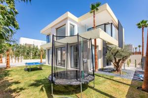 a house with a playground in front of it at Luxury Villa, Design, Comfort, Heated Pool, Games in Marrakech