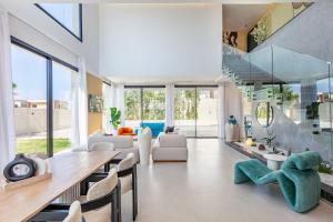 a living room with a long table and chairs at Luxury Villa, Design, Comfort, Heated Pool, Games in Marrakech