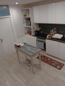 a kitchen with a table in the middle of it at Maison Au Bord de l'eau in Loches