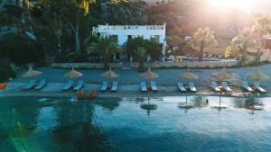 an image of a swimming pool with chairs and umbrellas at Villa Castelle in Marmaris