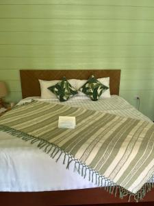 a bed with a sign on top of it at À La Koh Kood Resort in Ko Kood