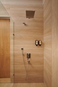 a bathroom with a shower with a cord plugged into a wall at Villa Castelle in Marmaris +66 photos