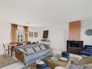a living room with a couch and a table at 400m de la plage, jardin, maison pour 8 in Le Gillieux