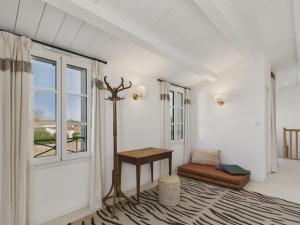 a living room with a table and a window at 400m de la plage, jardin, maison pour 8 in Le Gillieux
