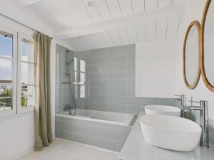a bathroom with a tub and a toilet and a sink at 400m de la plage, jardin, maison pour 8 in Le Gillieux +18 photos