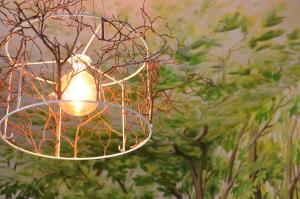 a light that is hanging from a tree at Pension Spreewelten in Lübbenau