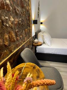 a room with a bed and a chair and a table at Archontiko Kantilis in Díon +28 photos