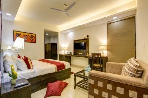 a hotel room with a bed and a chair at Hotel Park Tree IGI Airport Delhi With Free Airport Transfar in New Delhi