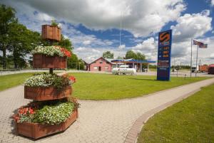 a display of flowers in wooden boxes in a park at Motelis Astarte in Koknese