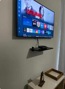 a flat screen tv hanging on a wall at Hospedagem Altas da Quitéria Suíte 01 in Catas Altas