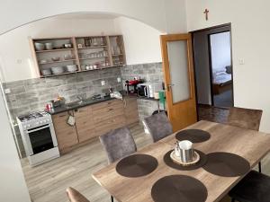 Una cocina y un comedor con una mesa de madera. en Ubytování u zastávky, en Modrá 38 fotos más
