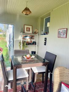 a dining room with a table and chairs at " Goarem Bihan" Villa de Charme Front de Mer in Plouarzel