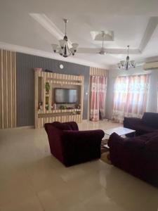 a living room with two couches and a tv at Apartment Brusubi in Mbarra Kunku