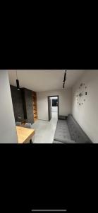 a living room with a couch and a clock on the wall at Lux Central Apartment in Kilkís