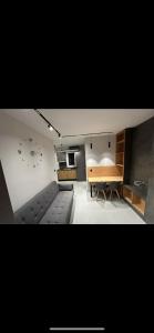 a living room with a couch and a table at Lux Central Apartment in Kilkís