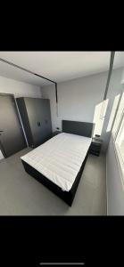 a bedroom with a large bed in a room with a window at Lux Central Apartment in Kilkís