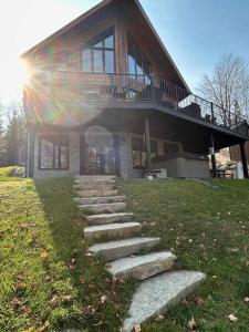 a house with a group of steps leading up to it at Lakefront - Spa - Pool table - Mistral 154 in Sainte-Marguerite