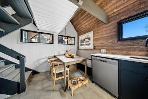 a small kitchen with a table and a sink at Spa & Nature view - Alpenglow in Sainte-Germaine-du-Lac-Etchemin