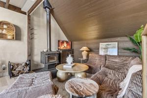 a living room with a couch and a fireplace at Spa & Nature view - Alpenglow in Sainte-Germaine-du-Lac-Etchemin