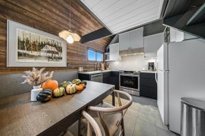 a kitchen with a table with fruits and vegetables on it at Spa & Nature view - Alpenglow in Sainte-Germaine-du-Lac-Etchemin +27 photos