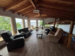 a living room with couches and chairs and a table at Heated Indoor Pool - Maison au Bord du Lac in Rigaud