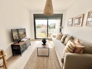 a living room with a couch and a tv at Mediterranean Way - Miami Beach in Miami Platja