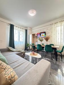a living room with a couch and a table at Studios Palas by GLAM Center Area and Mall - Parking Option in Iaşi